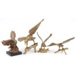 Three large brass eagles and a hand painted plaster eagle, the largest 61cm wide : For further