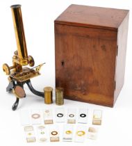 Victorian lacquered brass adjustable student's microscope with prepared slides housed in a fitted