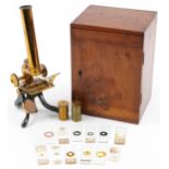 Victorian lacquered brass adjustable student's microscope with prepared slides housed in a fitted