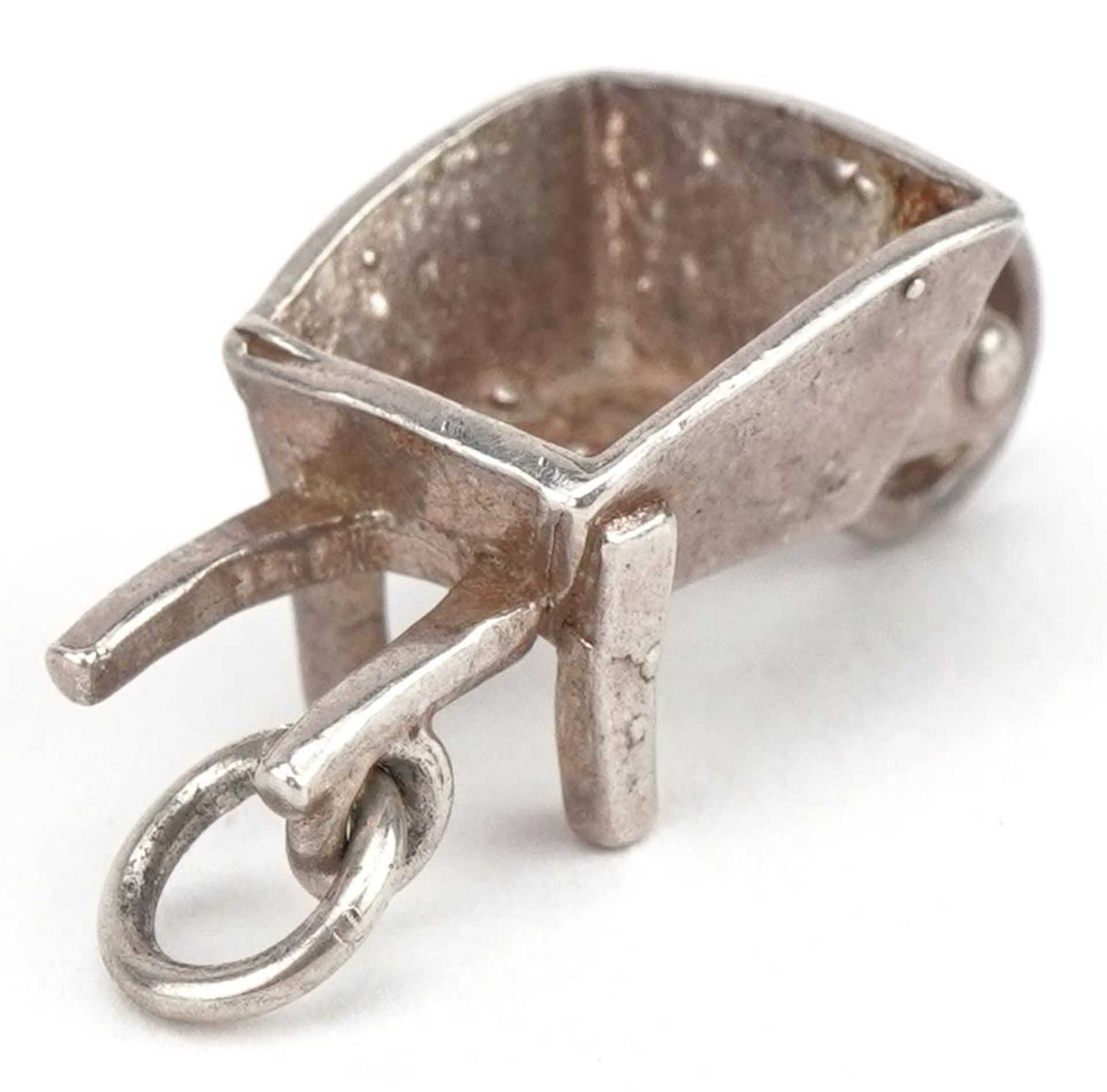 Unmarked silver wheelbarrow charm, 2.1cm in length, 2.5g : For further information on this lot - Image 2 of 2