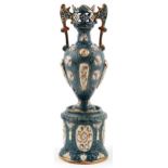 Continental Maiolica pierced vase with twin handles on a circular base, the vase and base each