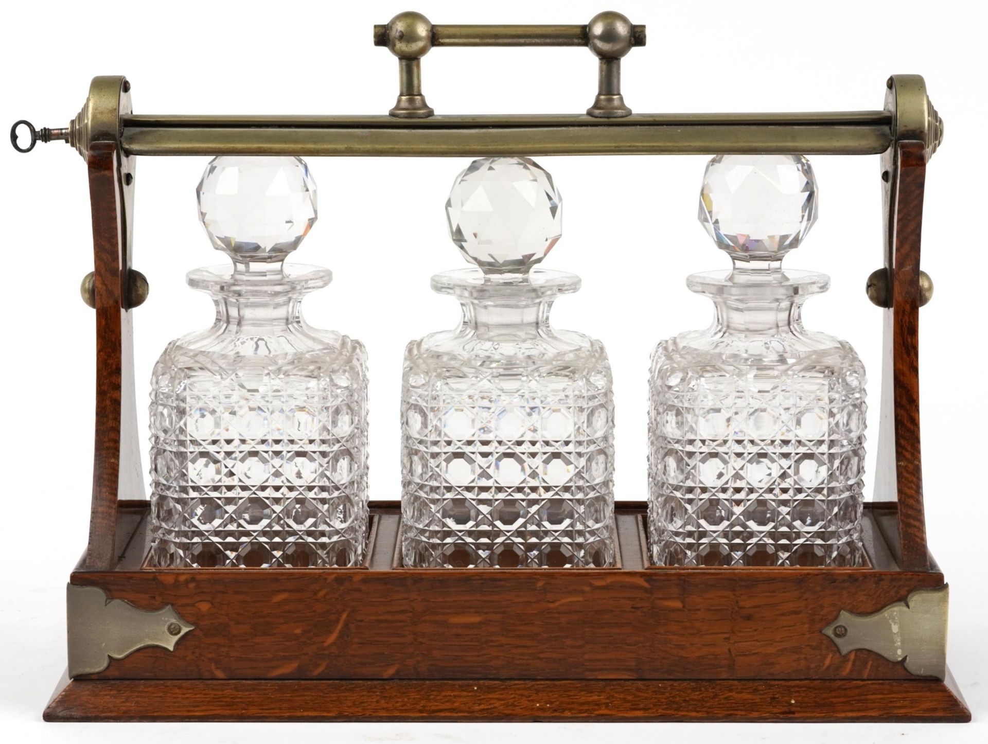 Edwardian oak Grimsell's Patent tantalus housing three cut glass decanters, 40cm wide : For - Image 4 of 5