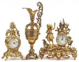 Two French Rococo style mantle clocks and a large brass ewer with C scroll decoration, the largest