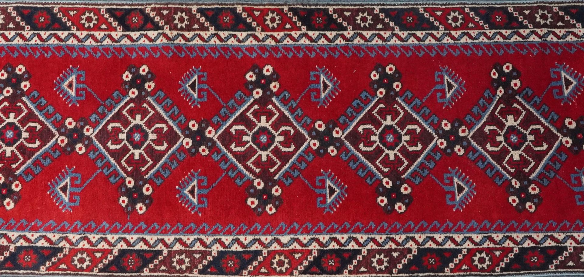 Turkish Red and blue ground carpet runner having an allover repeat geometric design, 295cm x - Image 3 of 5