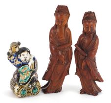 Pair of Chinese carved wood figures of Guanyin and a Japanese porcelain figure of a man holding a