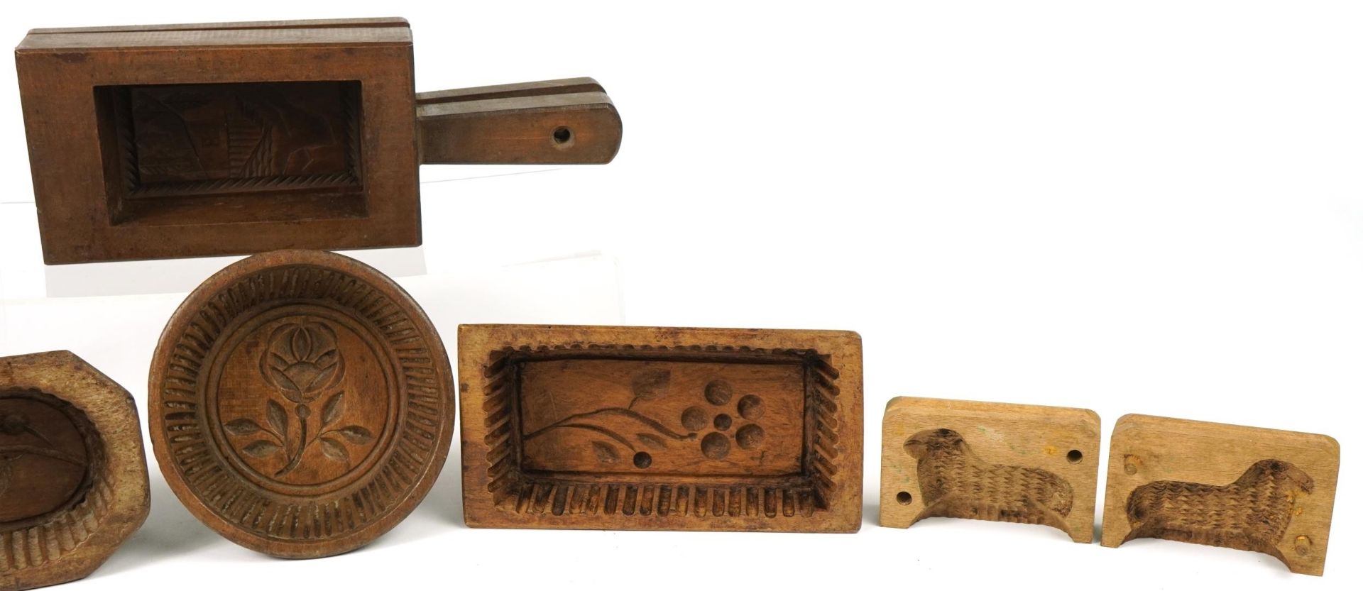 Six Antique French treen butter moulds including examples carved with flowers, the largest 20.5cm in - Image 3 of 5