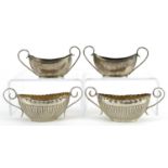 Two pairs of Victorian and later silver open table salts with twin handles, the largest 10.5cm wide,