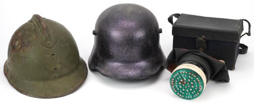Two military interest helmets and a gas mask with box : For further information on this lot please