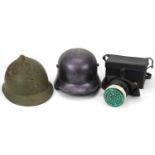 Two military interest helmets and a gas mask with box : For further information on this lot please