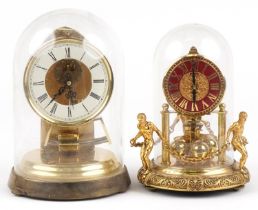 Two German brass cased anniversary clocks including one with figures and chains, the largest 24cm