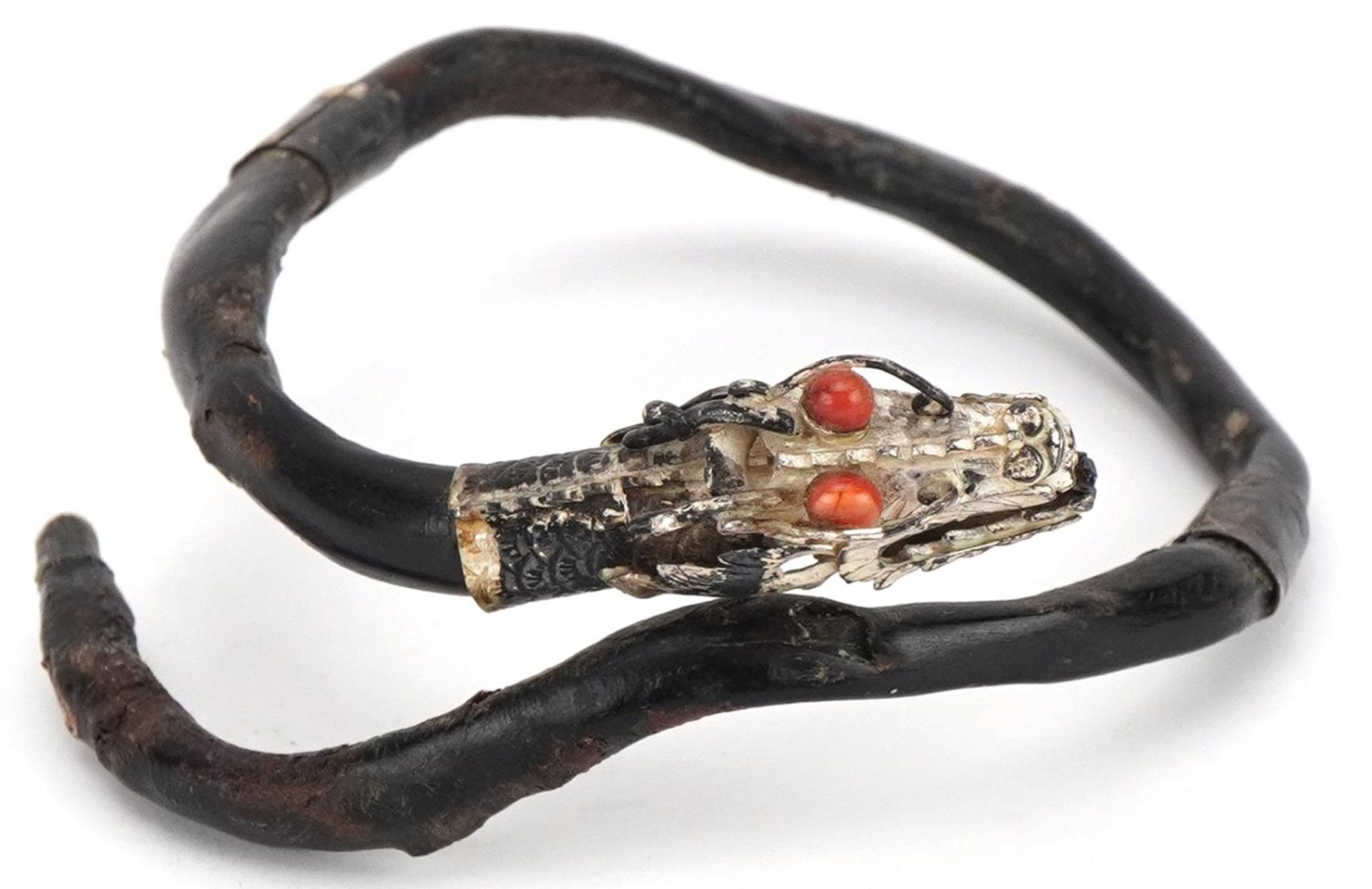 Antique Chinese silver mounted gnarled wood bangle in the form of a dragon with coral eyes, 7.5cm in