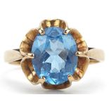 9ct gold blue topaz solitaire ring with pierced flower head setting, the topaz approximately 10.