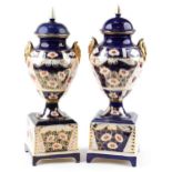 Large pair of Imari pattern pottery vases and covers with figural handles, each 61.5cm high : For