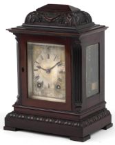 19th century carved mahogany mantle clock striking on a gong with silvered dial engraved with