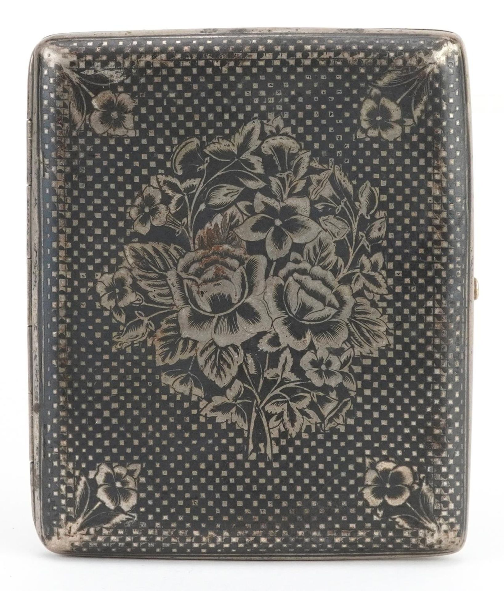 Persian silver niello work cigarette case decorated with flowers having a gilt interior, 8.5cm wide,