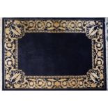 Large rectangular blue ground rug having a cream floral and Putti design border, 250cm x 169cm : For