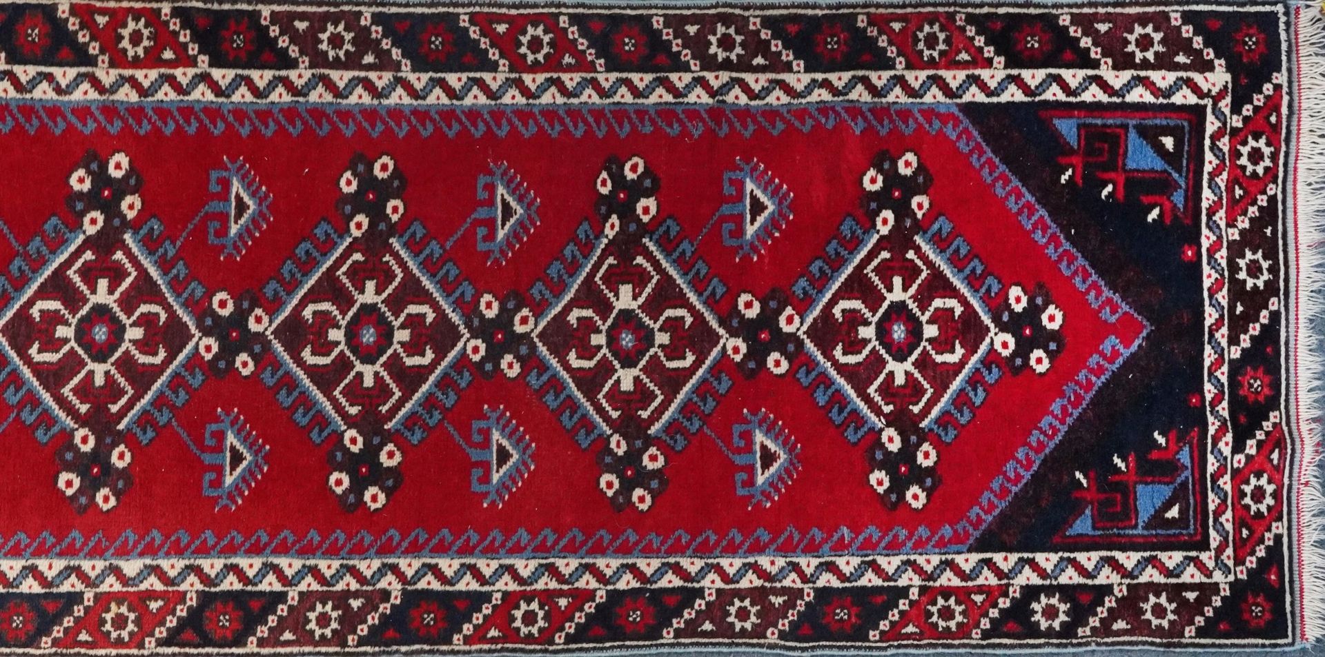 Turkish Red and blue ground carpet runner having an allover repeat geometric design, 295cm x - Image 4 of 5