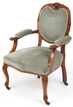 Victorian style armchair with olive green upholstery on cabriole legs with casters, 95cm high :