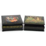 Two Russian black lacquered boxes with hinged lids including one hand painted with a figure on