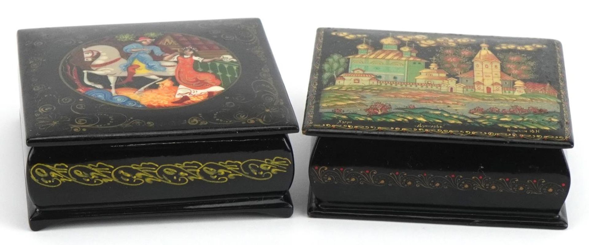 Two Russian black lacquered boxes with hinged lids including one hand painted with a figure on