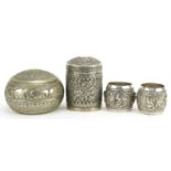 Burmese metalware including an unmarked silver cylindrical pot and cover, pair of unmarked silver