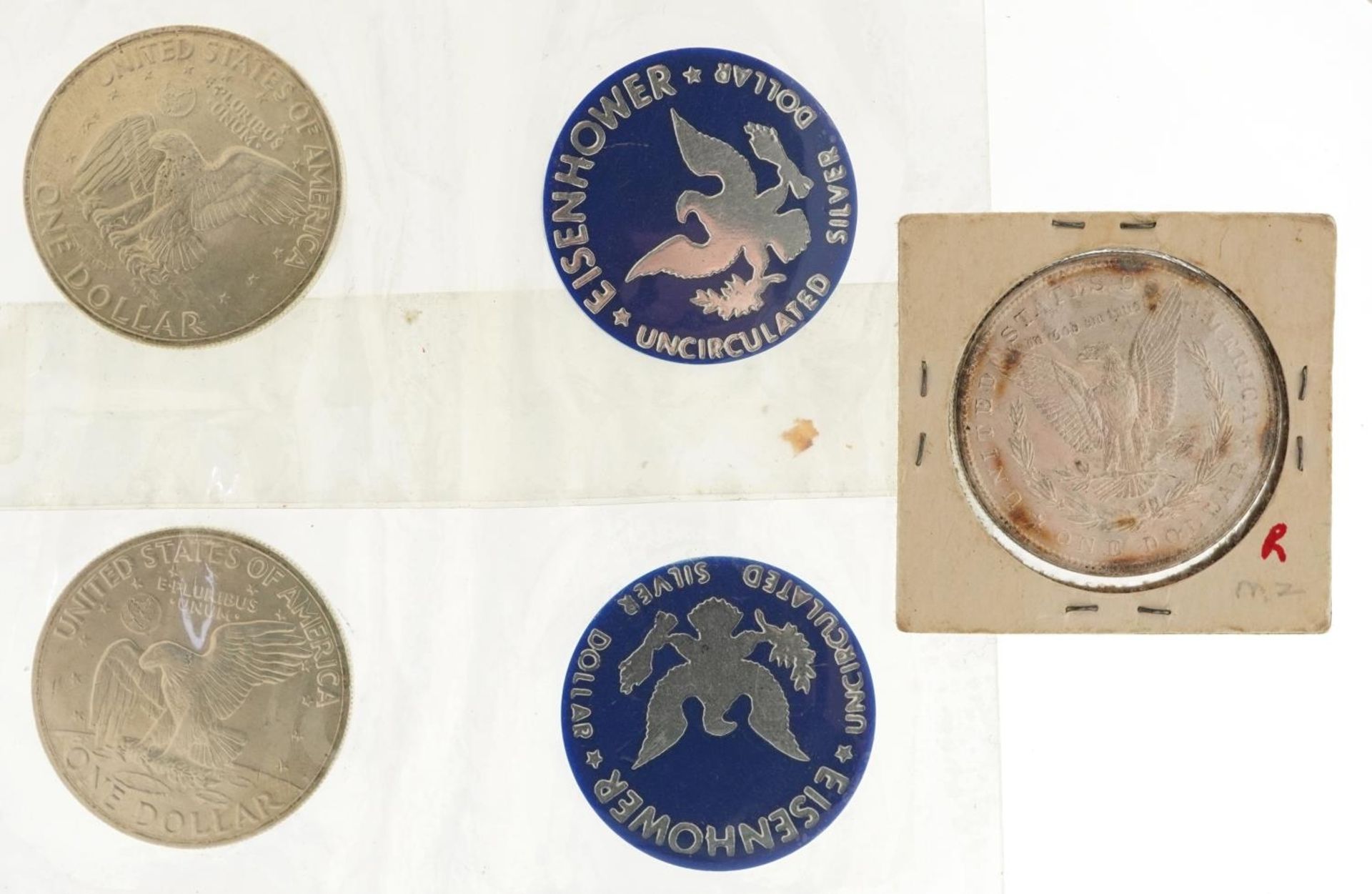 Three American dollars comprising 1889 Morgan dollar, Liberty Head dollar and two 1971 Eisenhower