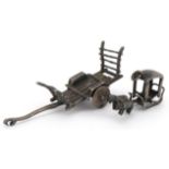 Asian unmarked silver miniature cart and a buffalo drawn cart charm, the largest 5.5cm in length,