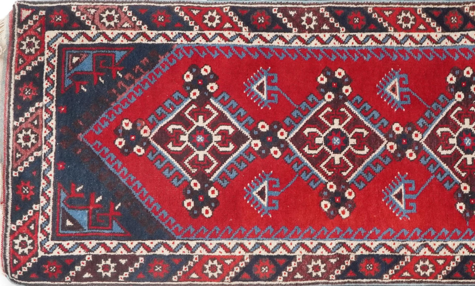 Turkish Red and blue ground carpet runner having an allover repeat geometric design, 295cm x - Image 2 of 5
