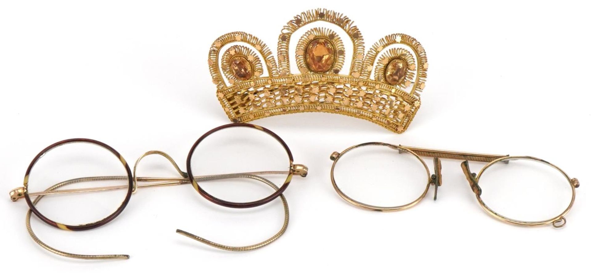 Two pairs of antique yellow metal spectacles and a yellow metal crown brooch set with orange stones,