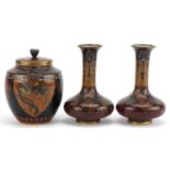 Japanese cloisonne comprising a pair of vases and a jar and cover enamelled with phoenixes and