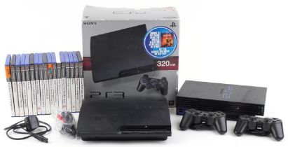 Sony PlayStation 3 and PlayStation 2 games consoles with controllers and a collection of PlayStation