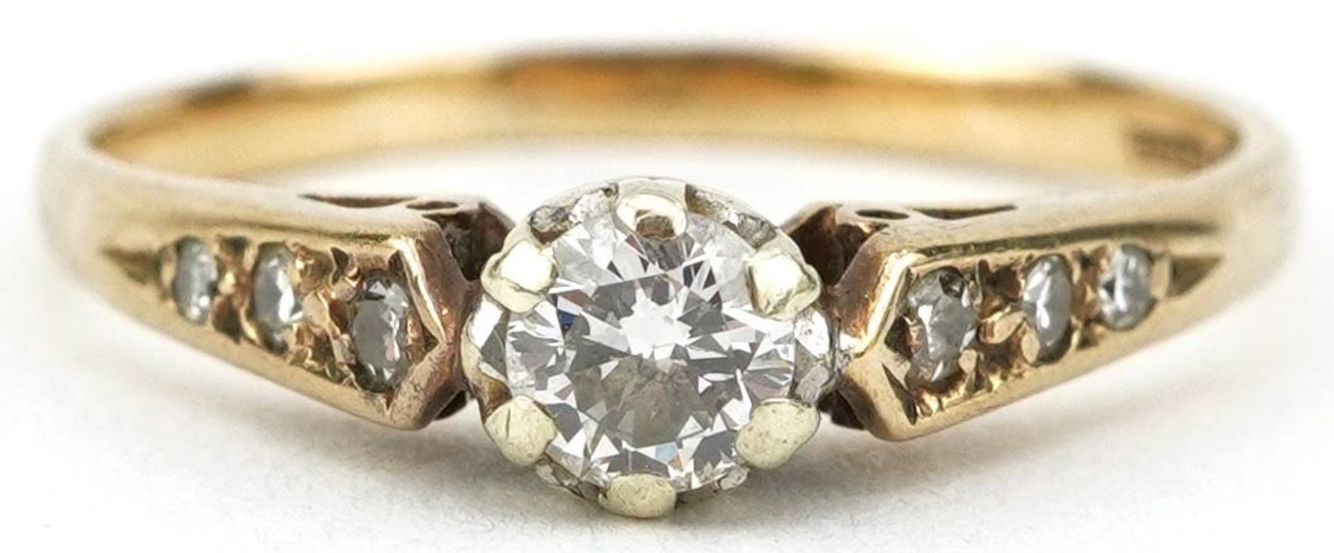 9ct gold diamond solitaire ring with diamond set shoulders, the central diamond approximately 0.20
