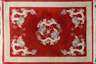 Chinese red and cream carpet decorated with dragons chasing the flaming pearl and Greek key