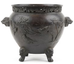 Japanese patinated bronze four footed jardiniere with pierced border and animalia handles carved
