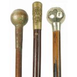 Three military interest swagger sticks with regimental pommels, the largest 71cm in length : For
