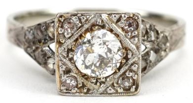 Art Deco 18ct white gold and platinum diamond ring with pierced shoulders, the central diamond