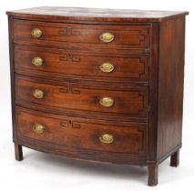 Georgian line inlaid mahogany bow front four drawer chest with ornate brass lion mask handles, 103cm