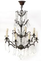 Bohemian style bronzed eight branch chandelier with cut glass drops, approximately 68cm high : For