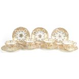 Victorian teaware gilded with flowers including four cups with sauces, the largest each 14cm in
