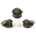 Three German military interest peak caps with badges : For further information on this lot please