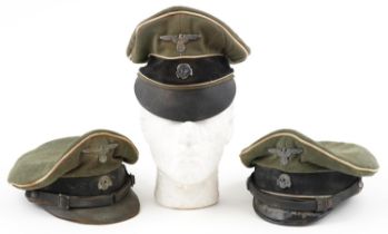 Three German military interest peak caps with badges : For further information on this lot please