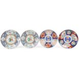 Four Japanese porcelain chargers including a pair hand painted with figures and panels of flowers,