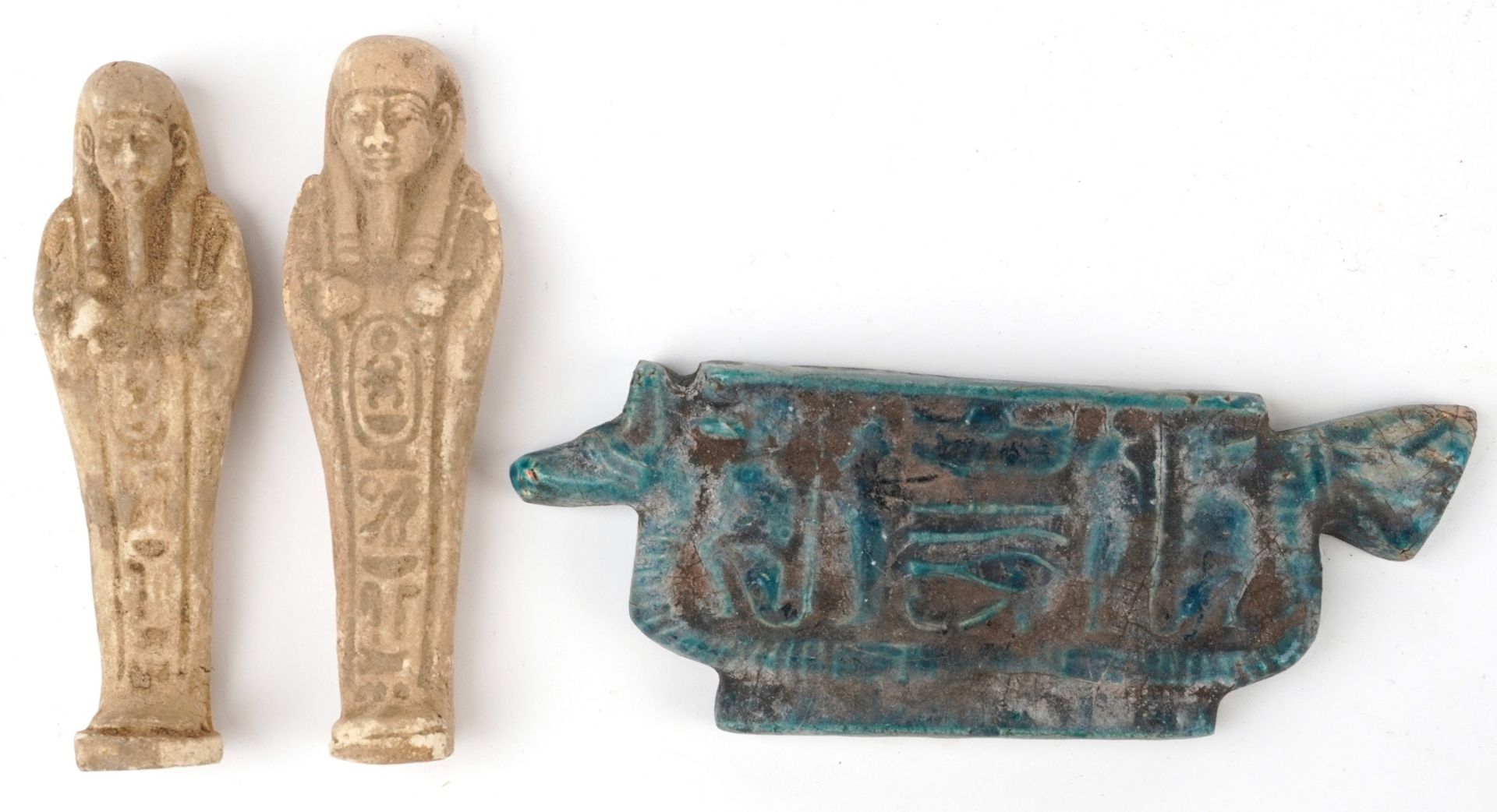 Two Egyptian style ushabtis and a faience glazed amulet, the largest 16cm wide : For further