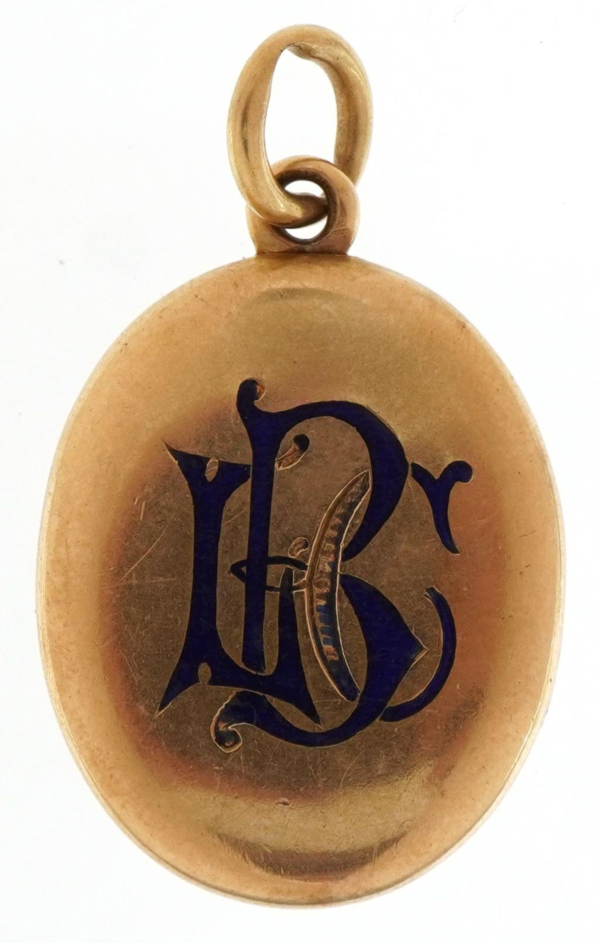Victorian unmarked gold oval locket with blue enamel monogram, tests as 15ct gold, 3.8cm high, 9.8g
