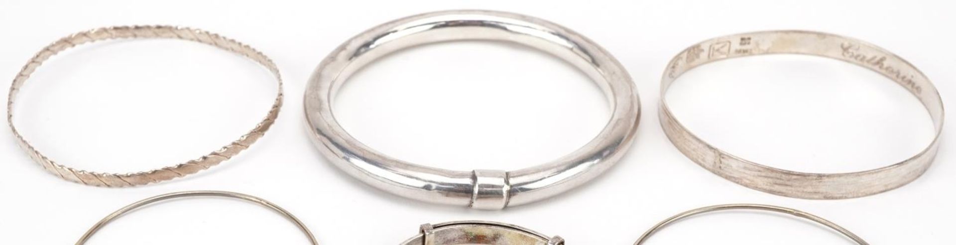 Six silver and white metal bangles including a christening bangle, the largest 8cm in diameter, - Image 2 of 6
