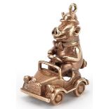 9ct gold charm in the form of a comical pig driving a car, 2.8cm high, 8.5g