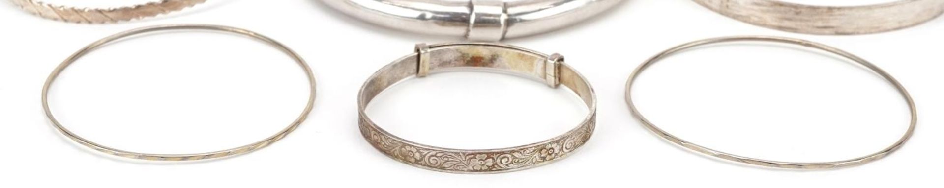 Six silver and white metal bangles including a christening bangle, the largest 8cm in diameter, - Image 3 of 6
