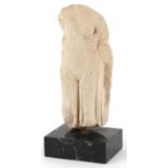 Hellenistic style carving of a scantily dressed female wearing a robe raised on a rectangular