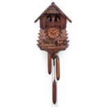 German Black Forest wall clock carved with a farrier beside horse and foal, 36cm high