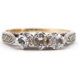 18ct gold and platinum diamond three stone ring with diamond set shoulders, the central diamond